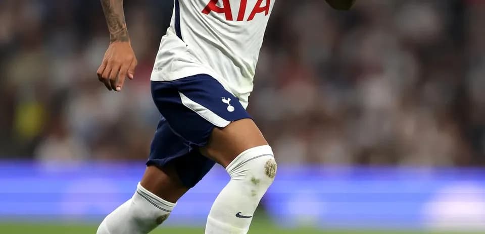 Player running with ball during match for Tottenham