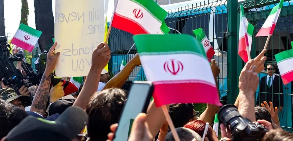 Crowd waving Iranian flags during a protest