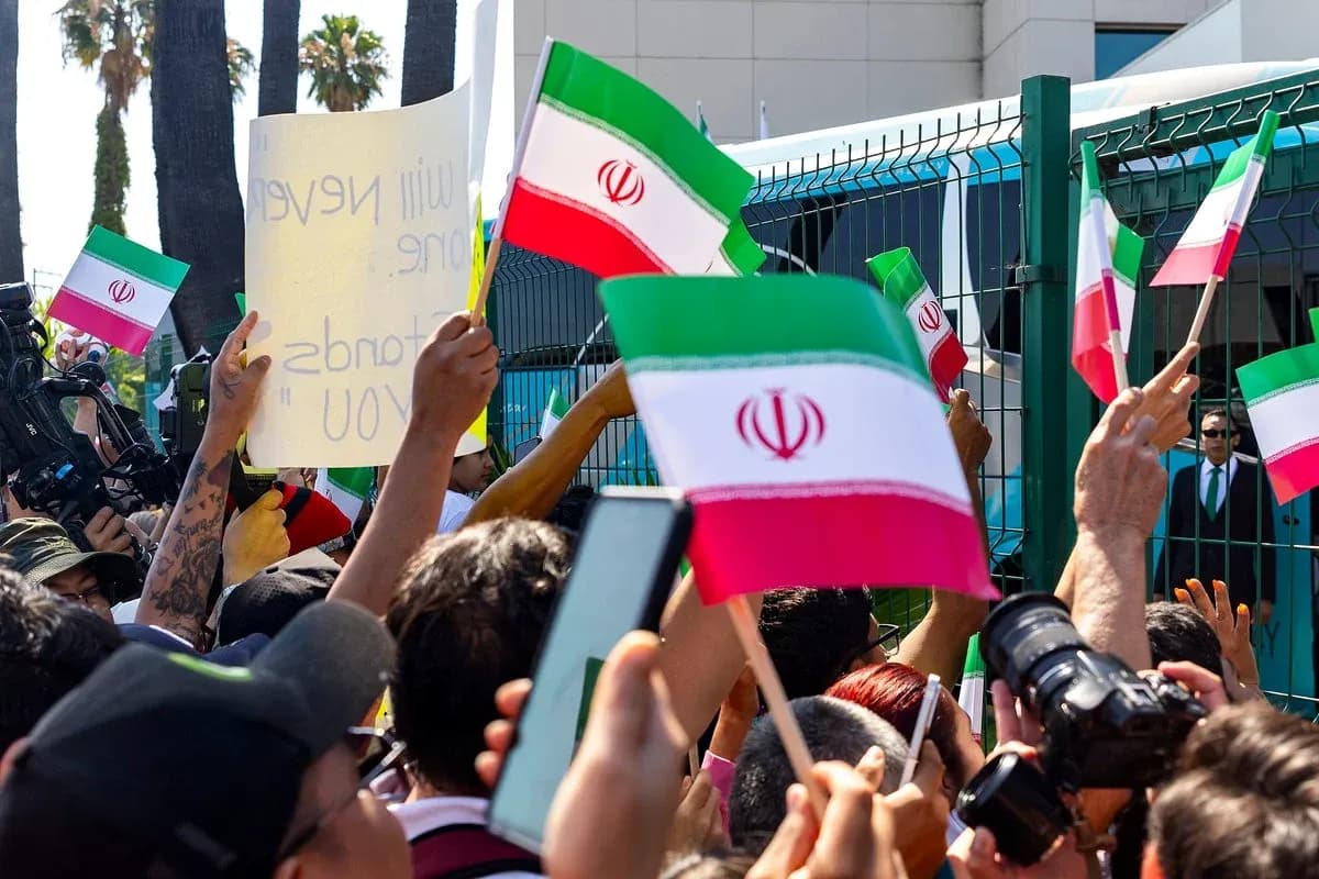 Crowd waving Iranian flags during a protest