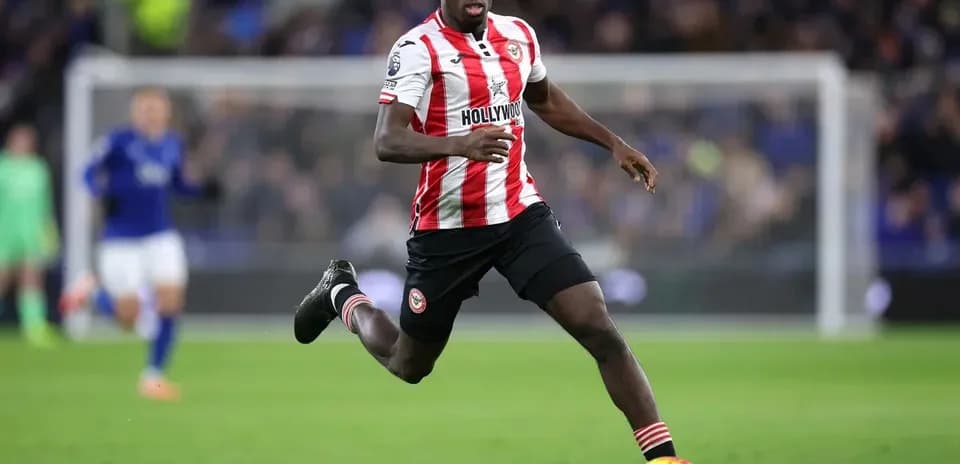 Brentford player sprinting on the pitch during match