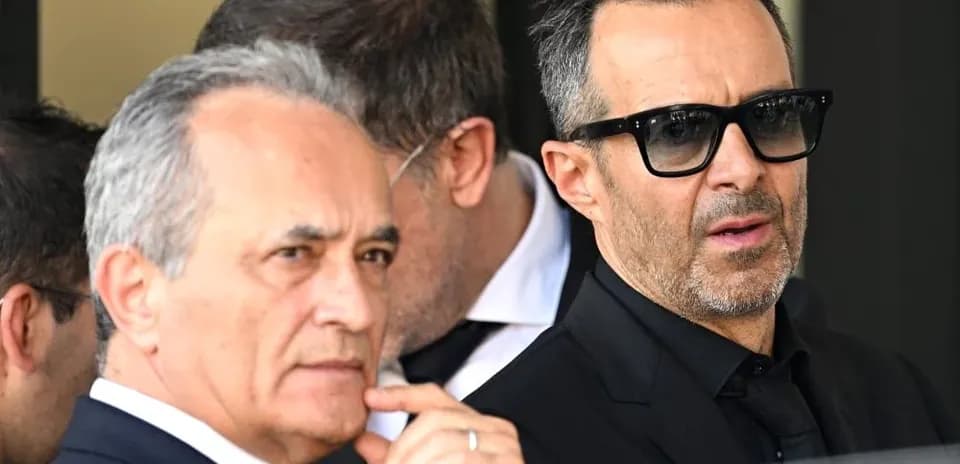 Two men in suits with sunglasses outdoors