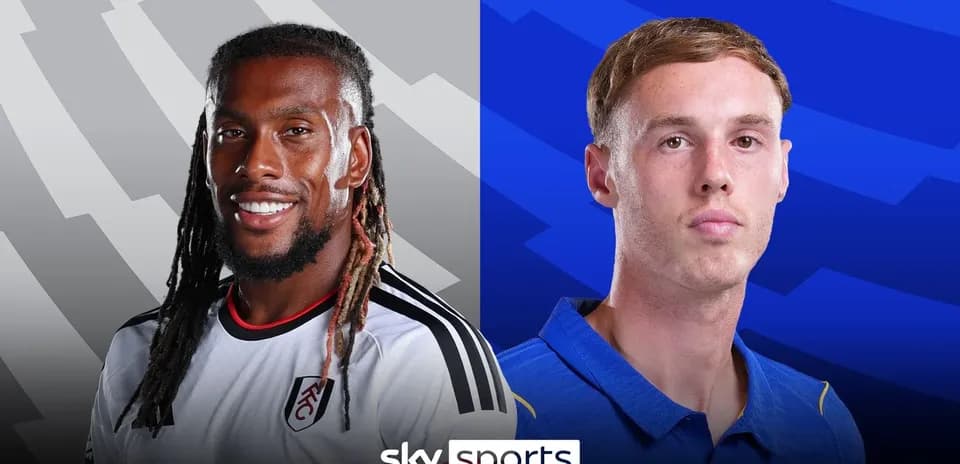 Two football players from opposing teams facing camera