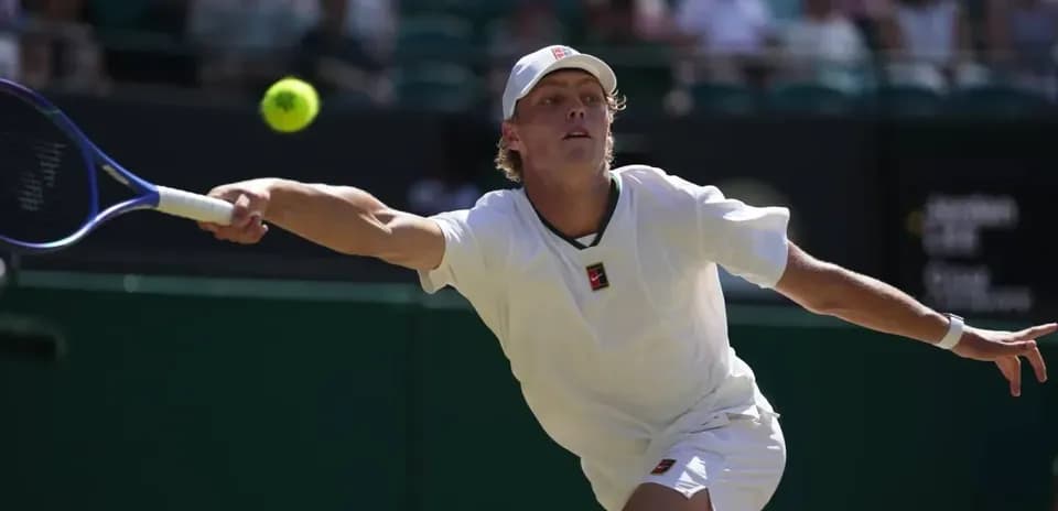 Player reaching for a tennis ball during match