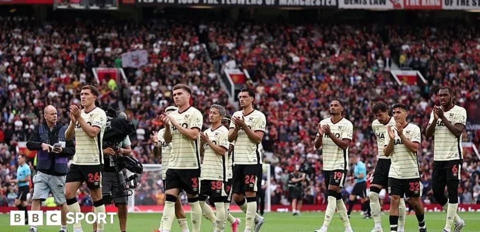 Players applauding fans at Old Trafford stadium