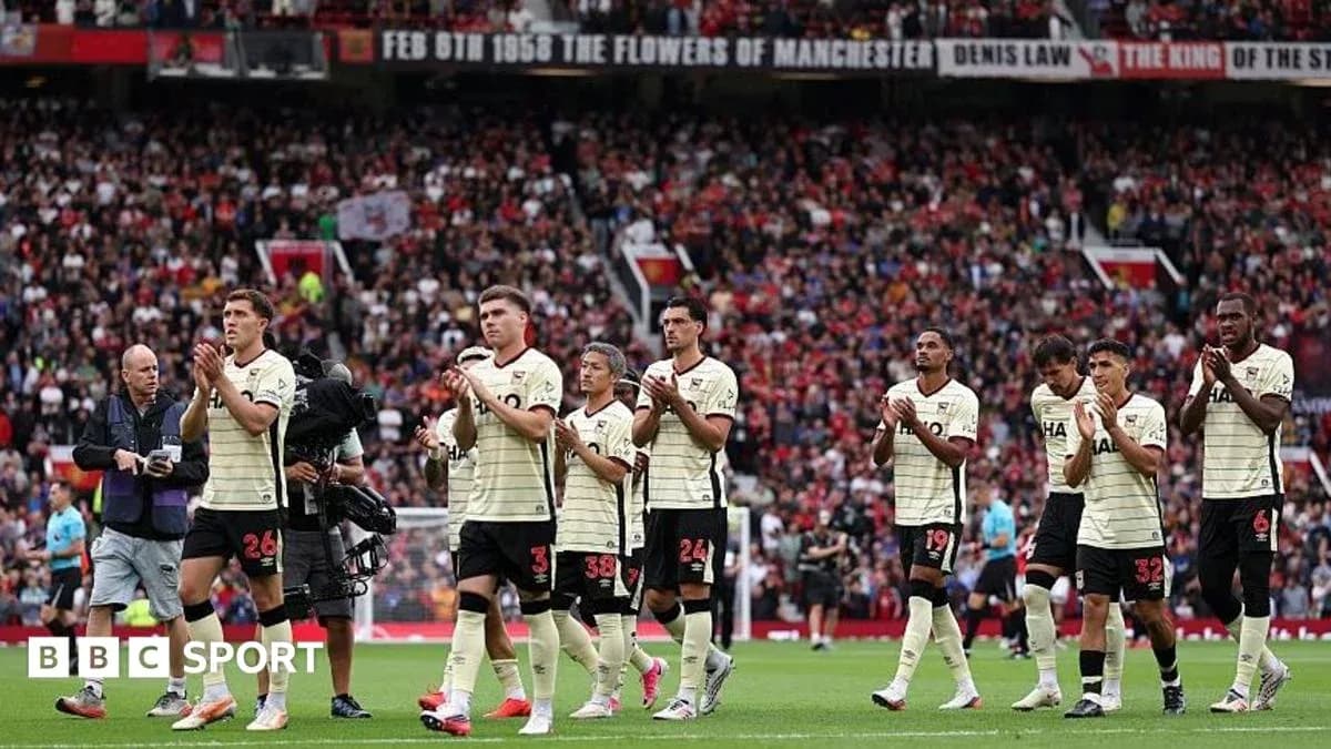Players applauding fans at Old Trafford stadium
