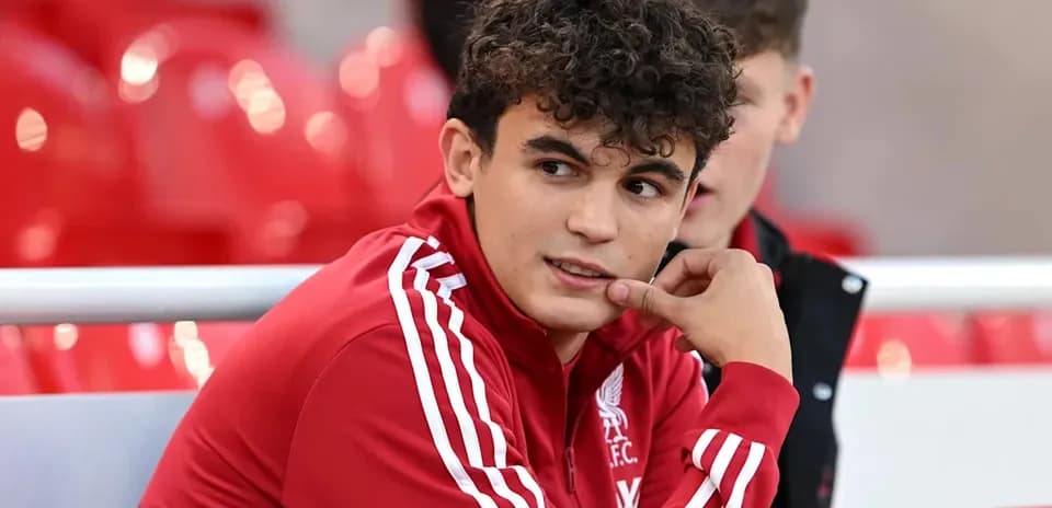 Player in Liverpool FC tracksuit on bench