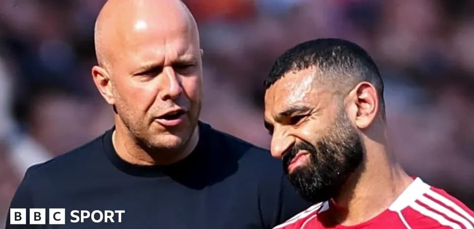 Coach discussing strategy with player on field