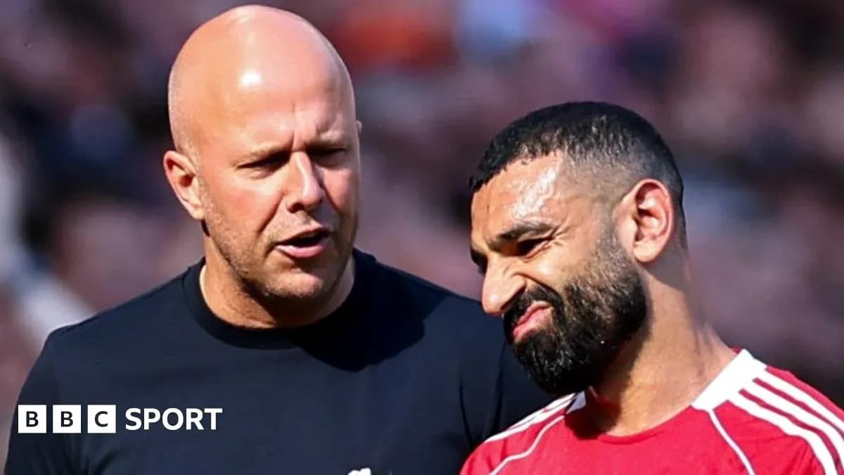 Coach discussing strategy with player on field