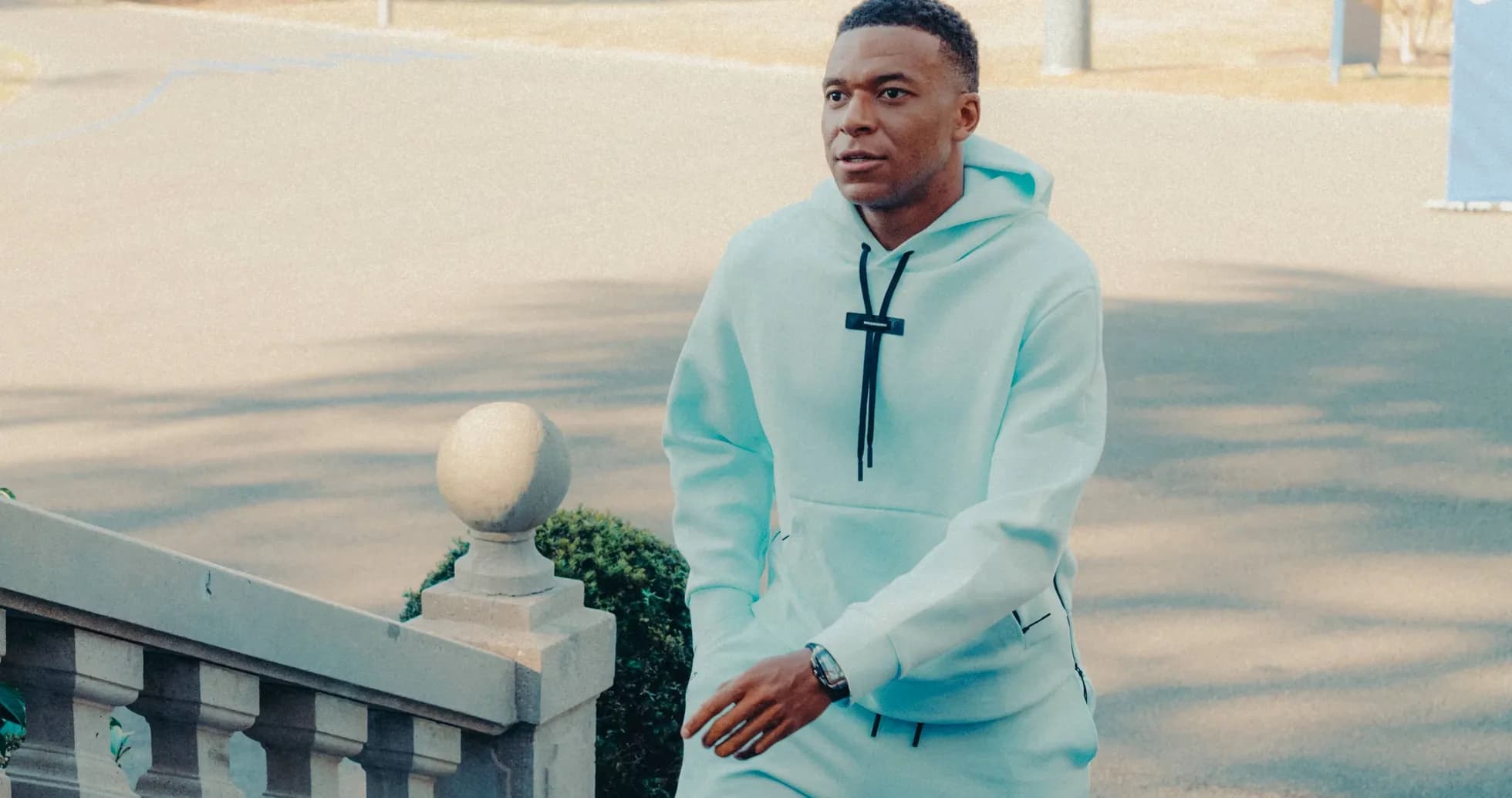 Player walking up stairs in light blue tracksuit