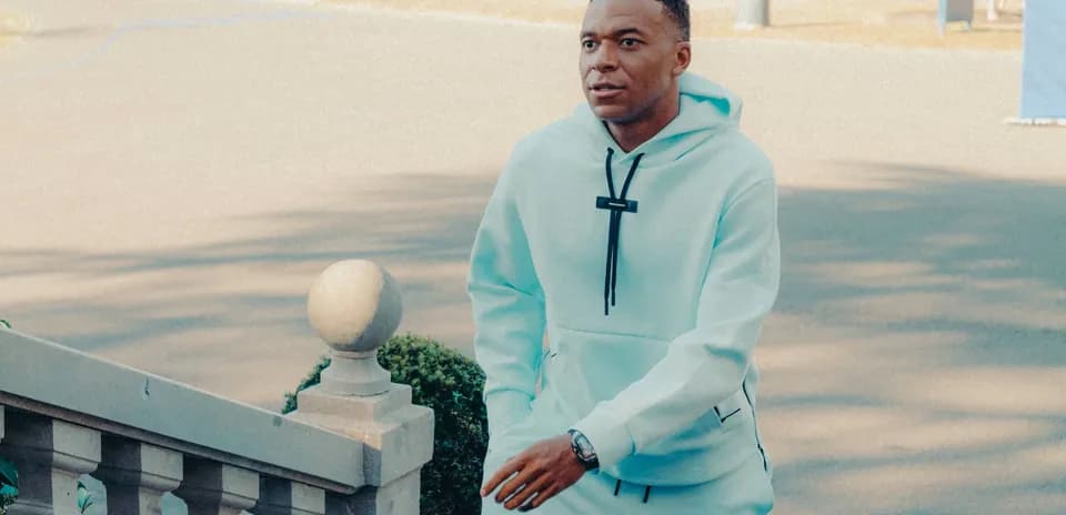 Player walking up stairs in light blue tracksuit