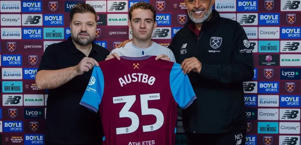 Player holding jersey during club signing announcement