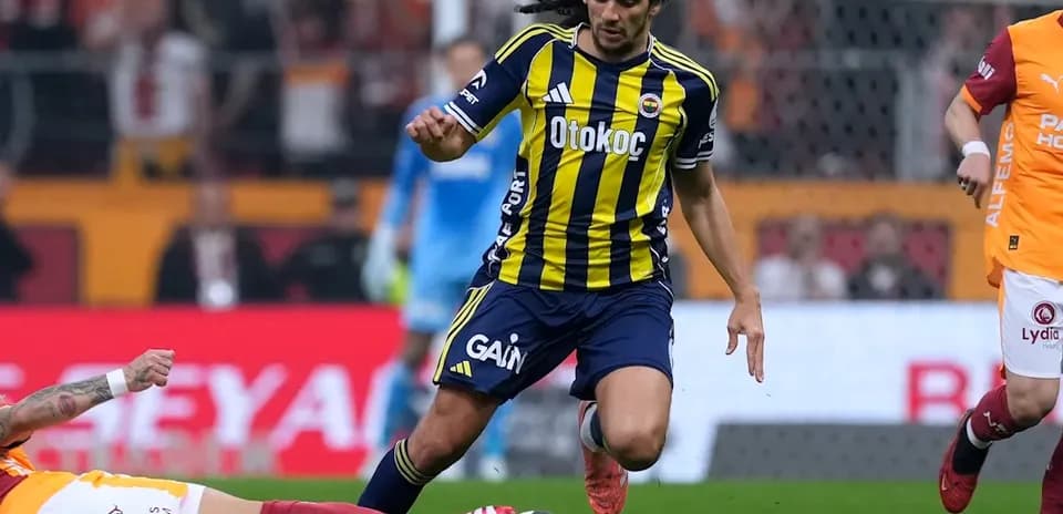Player in yellow and blue jersey dribbling past opponent