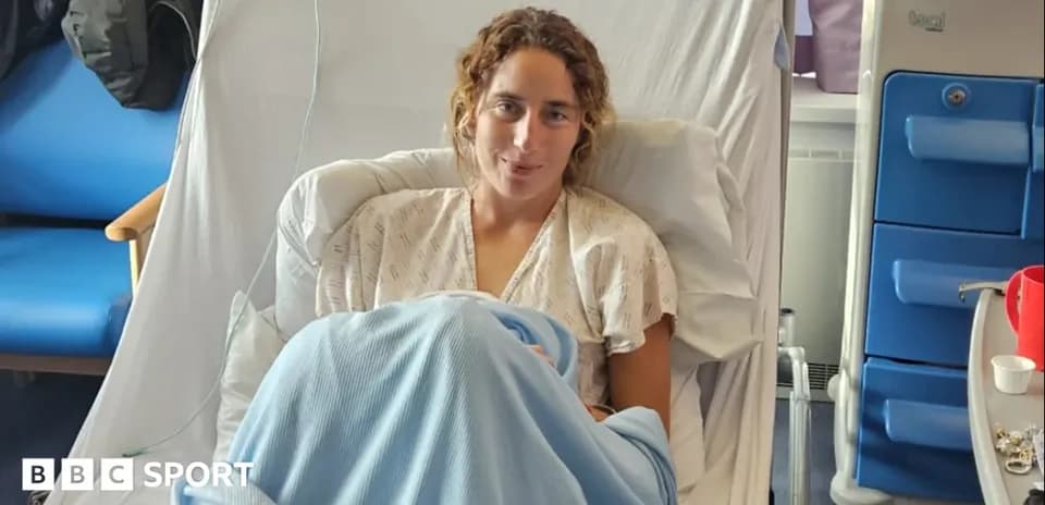 Athlete resting in hospital bed with blanket