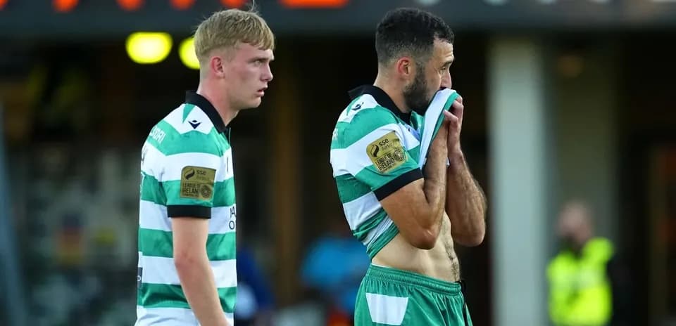 Two players in green and white jerseys after match