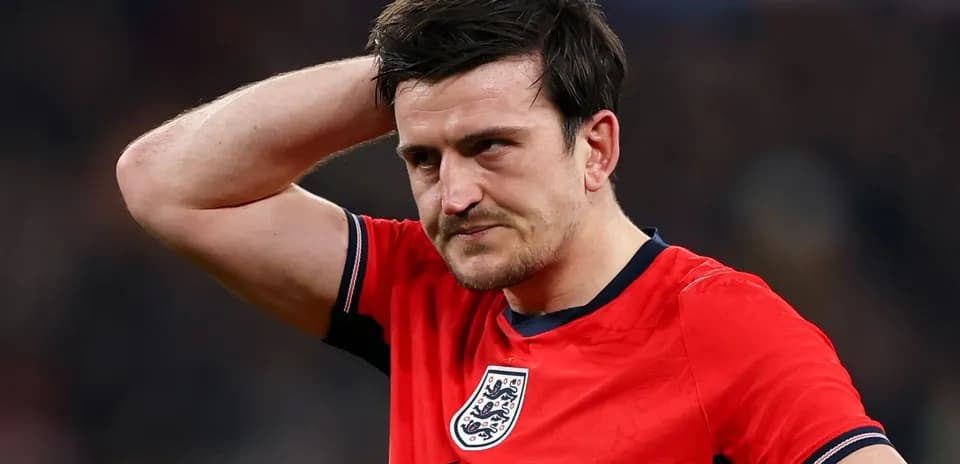 Player in red jersey with England badge looks concerned