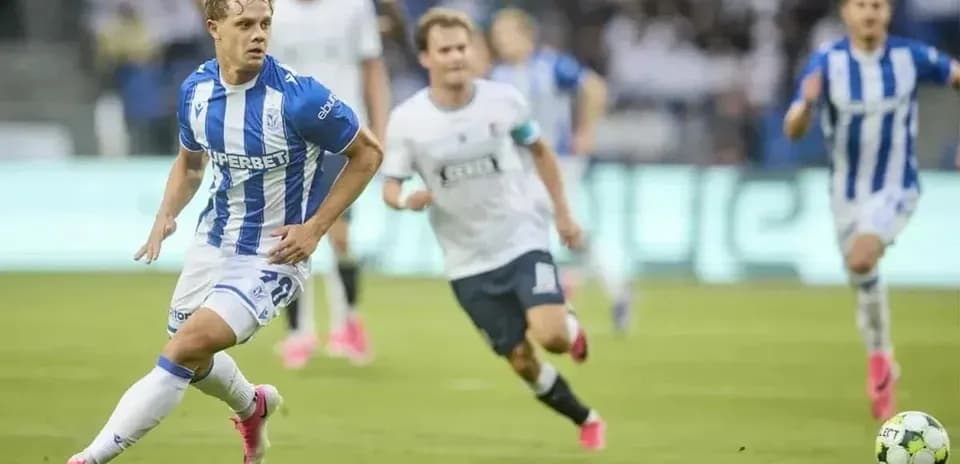 Lech Poznan player dribbling past opponents