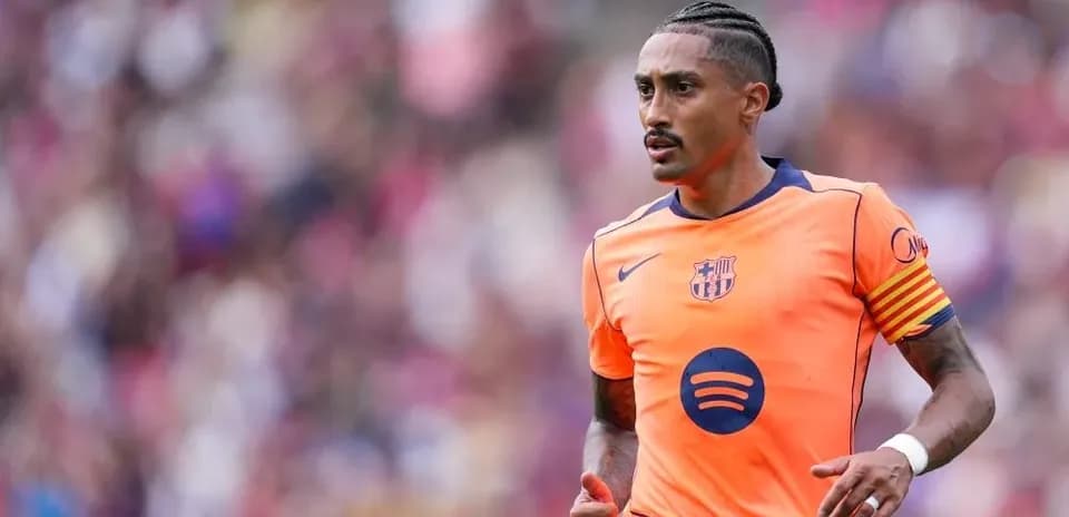 Player wearing orange Barcelona kit during match