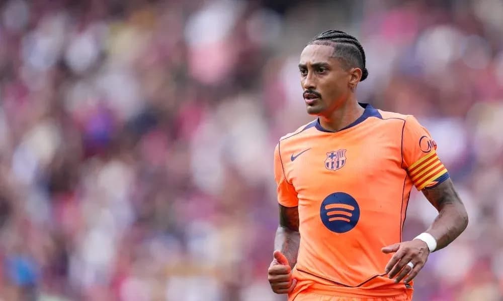 Player wearing orange Barcelona kit during match