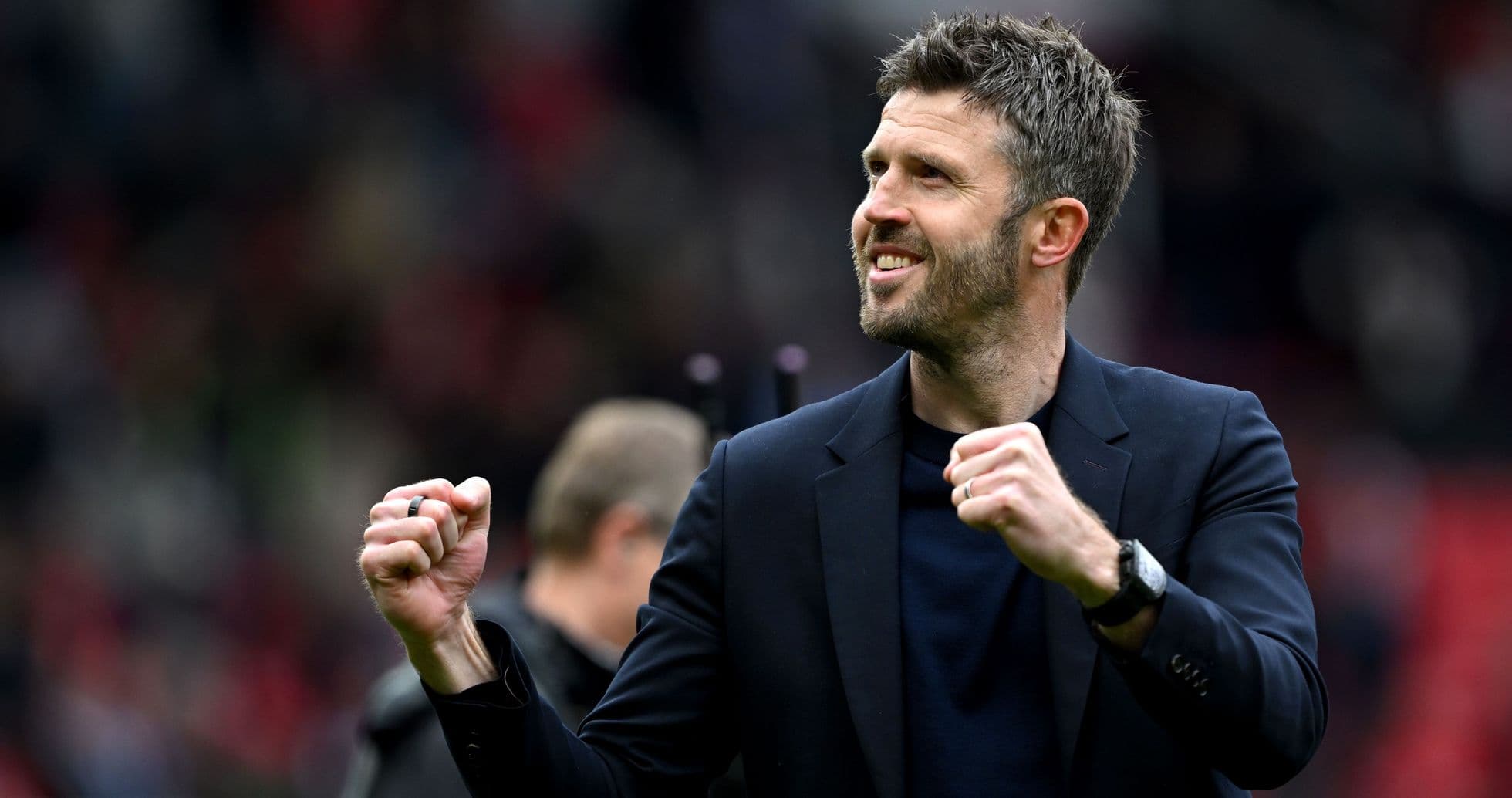 Coach celebrating enthusiastically on the pitch