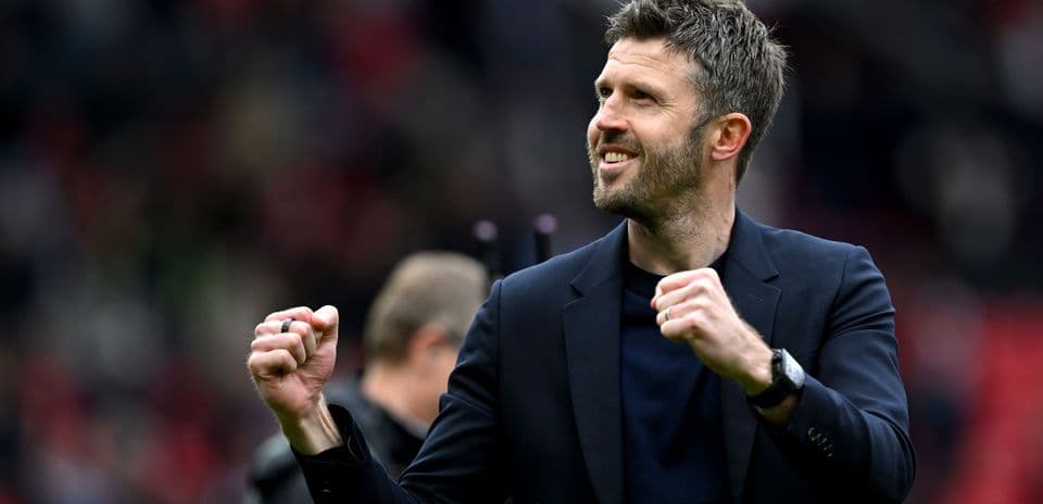 Coach celebrating enthusiastically on the pitch