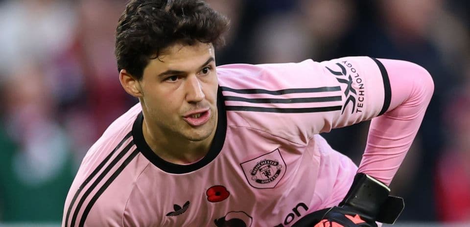 Goalkeeper in pink kit preparing for play