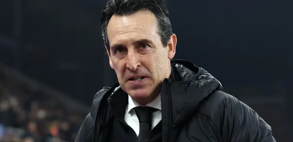 Coach in a black jacket during match