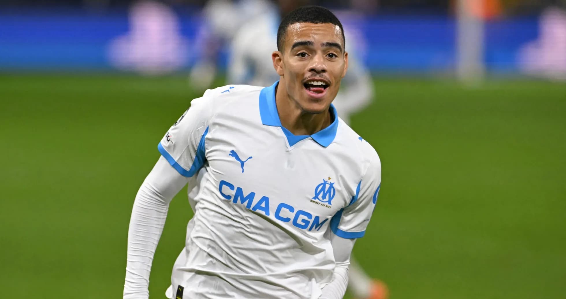 Player celebrating goal in Marseille home jersey