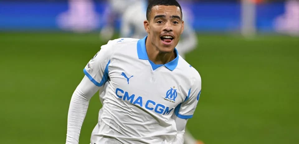 Player celebrating goal in Marseille home jersey
