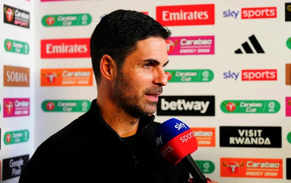 Manager speaking during post-match interview with microphone