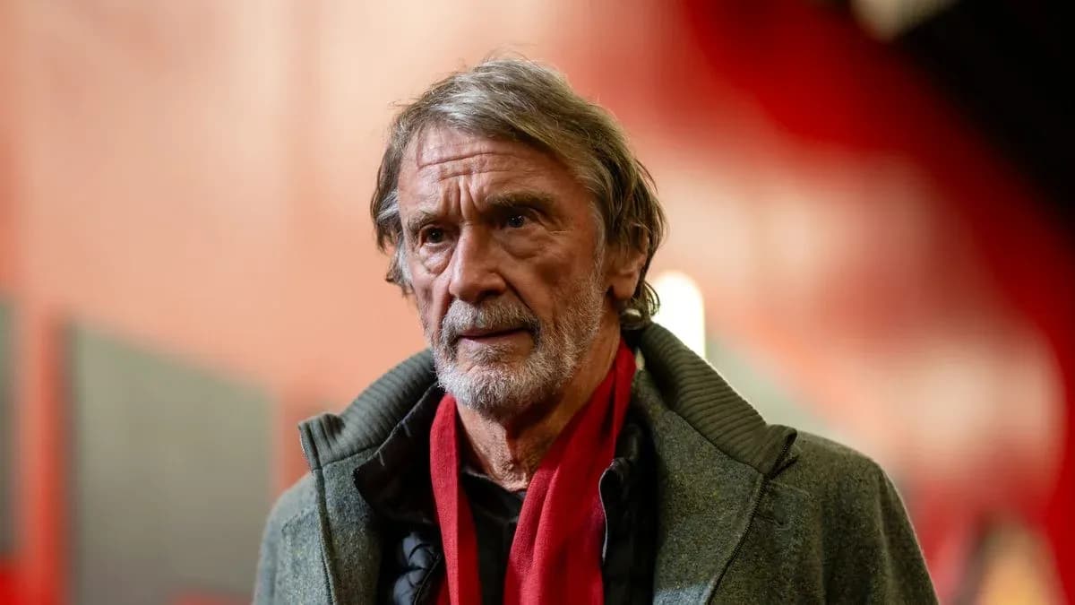 Man with gray hair and scarf in corridor