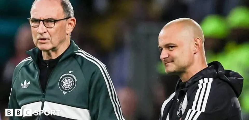 Two coaches discussing strategies on the sidelines