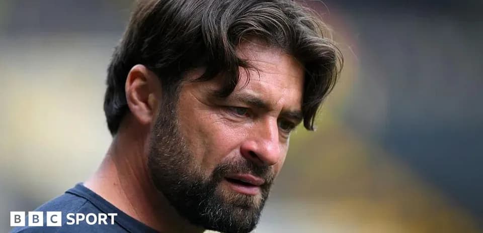 Coach focused during match preparation on the field