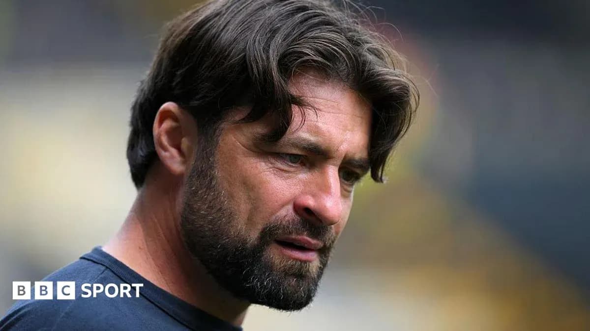 Coach focused during match preparation on the field