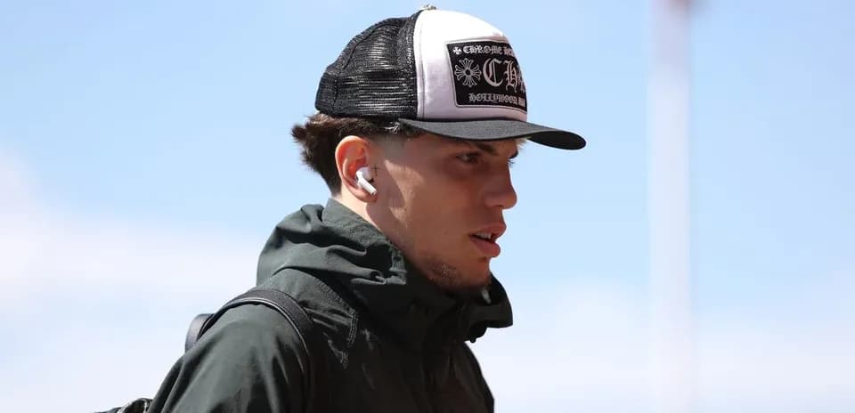 Player wearing cap and earbuds walking outdoors