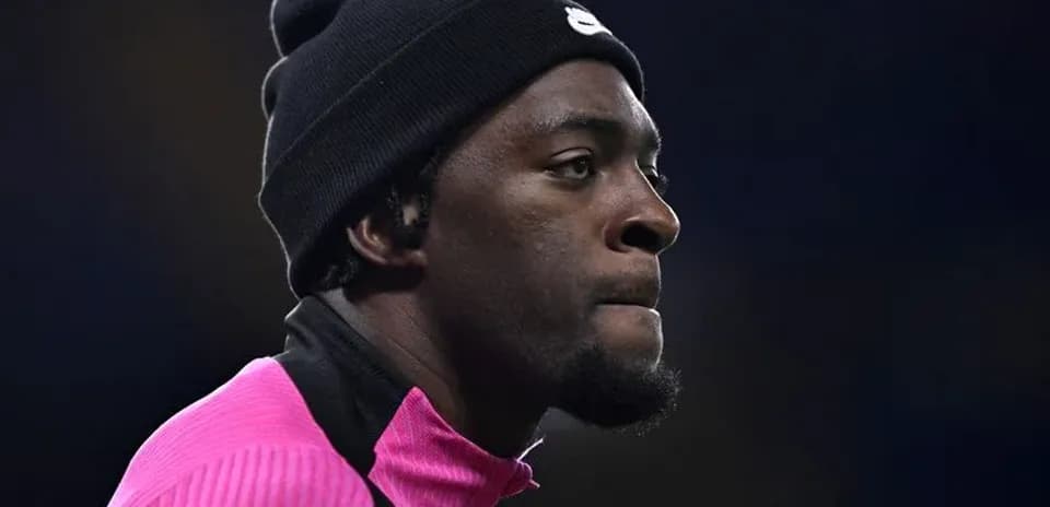 Player in pink training gear wearing a black beanie