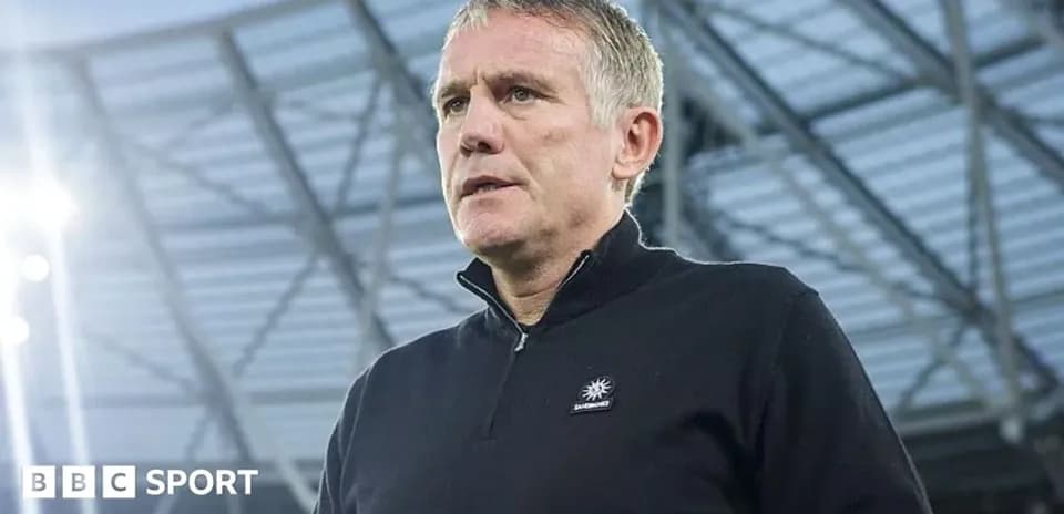 Manager speaking during press conference at stadium