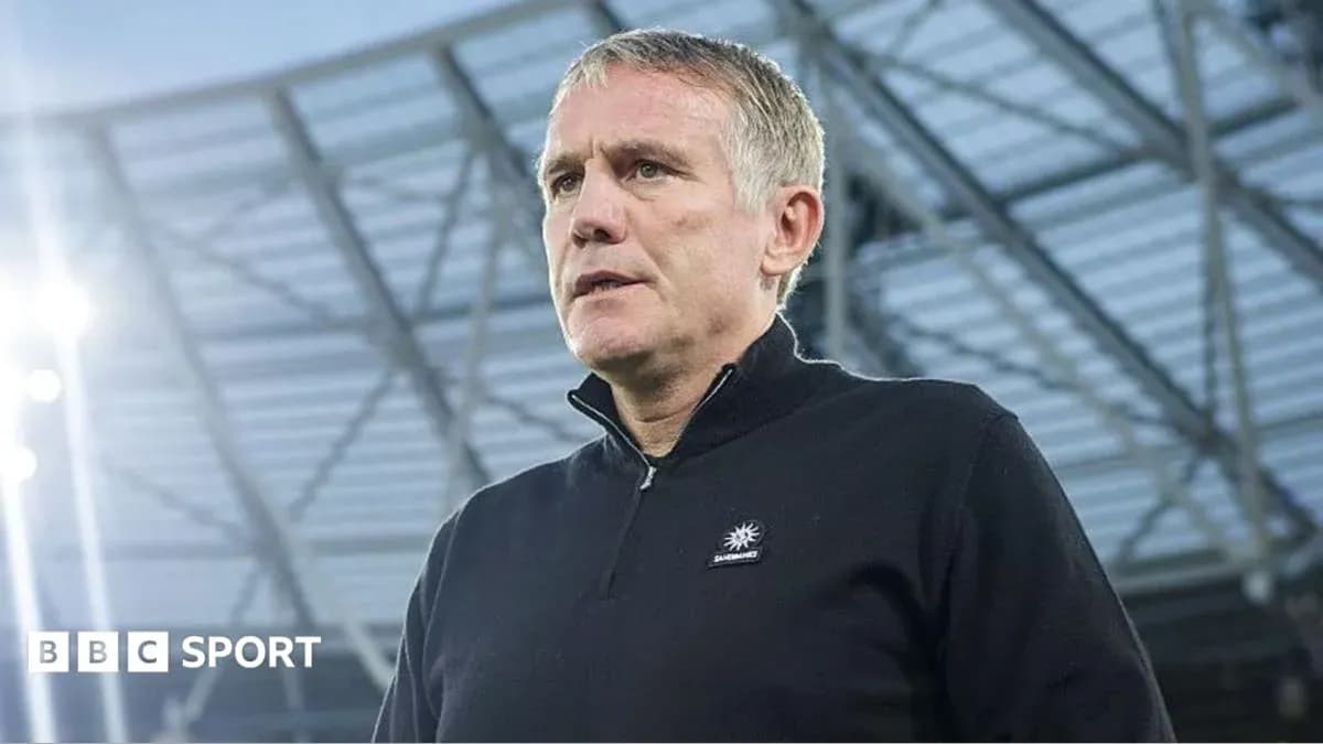 Manager speaking during press conference at stadium