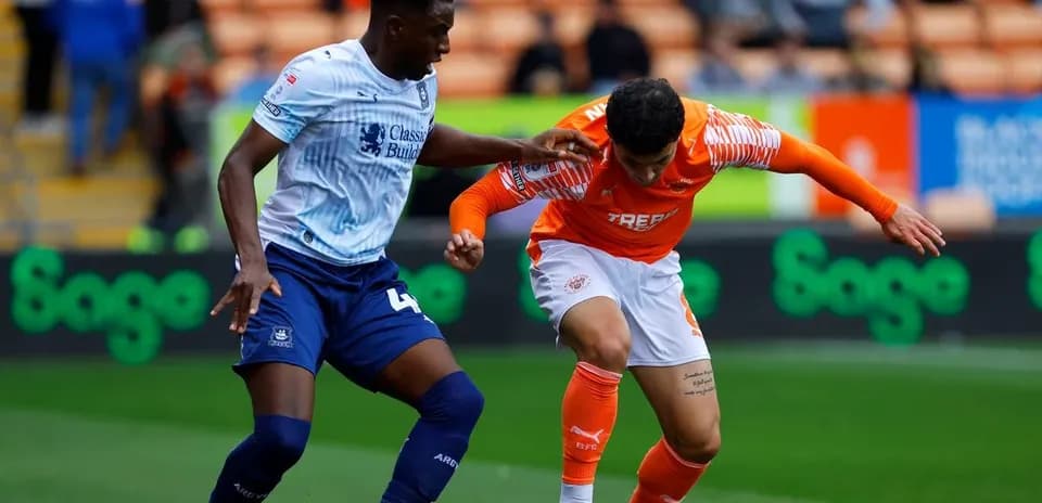 Two players battling for the ball during match