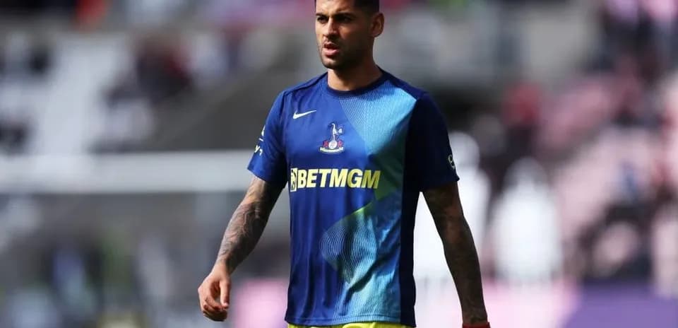 Player walking on the pitch in warm-up attire