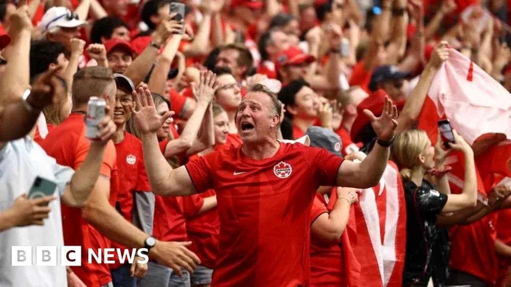 Fans celebrating in red during sporting event