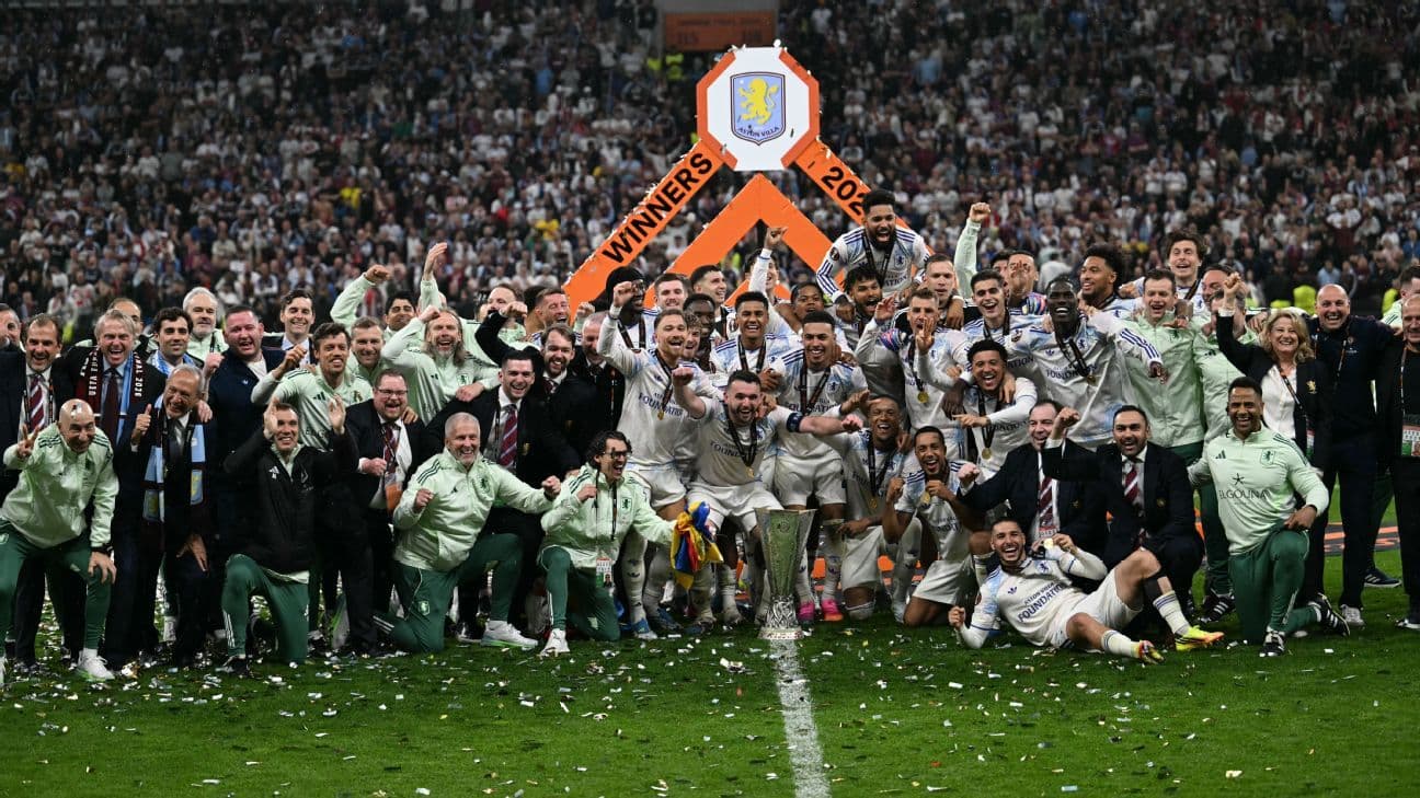Aston Villa celebrating victory with trophy on field