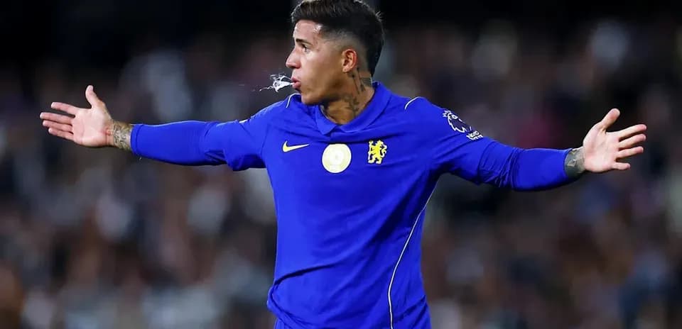 Player gesturing during match wearing Chelsea jersey