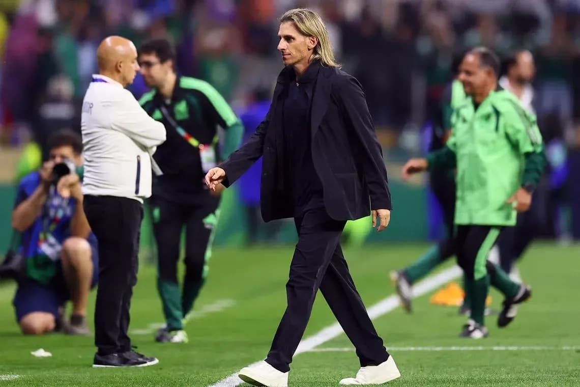 Coach walking on the pitch after the match