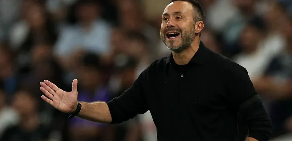 Manager gesturing during a match from the sidelines