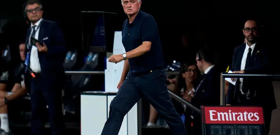 Coach walking along the sideline during match