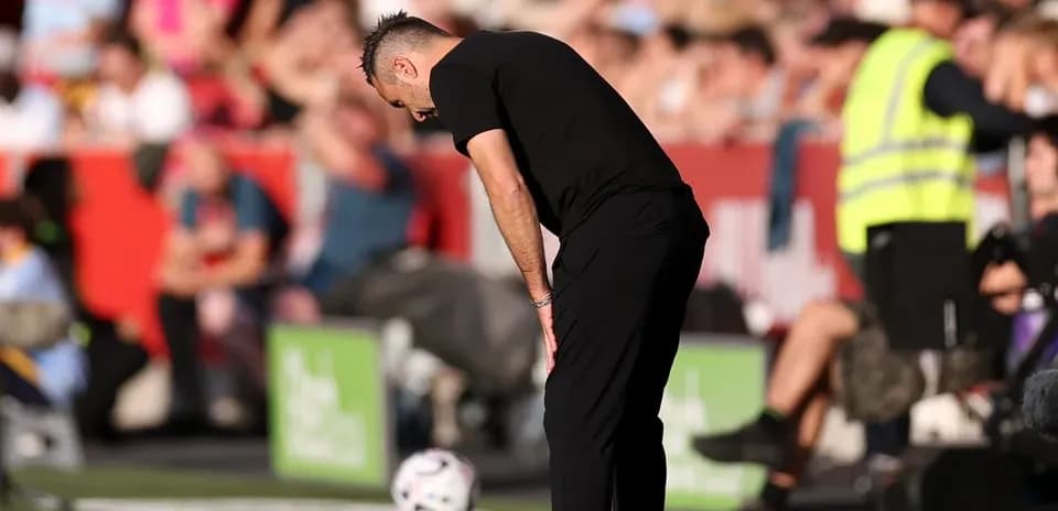 Coach observing the game with head bowed