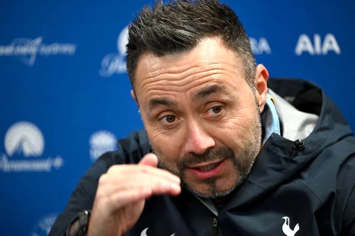 Manager speaking during press conference with hand gesture