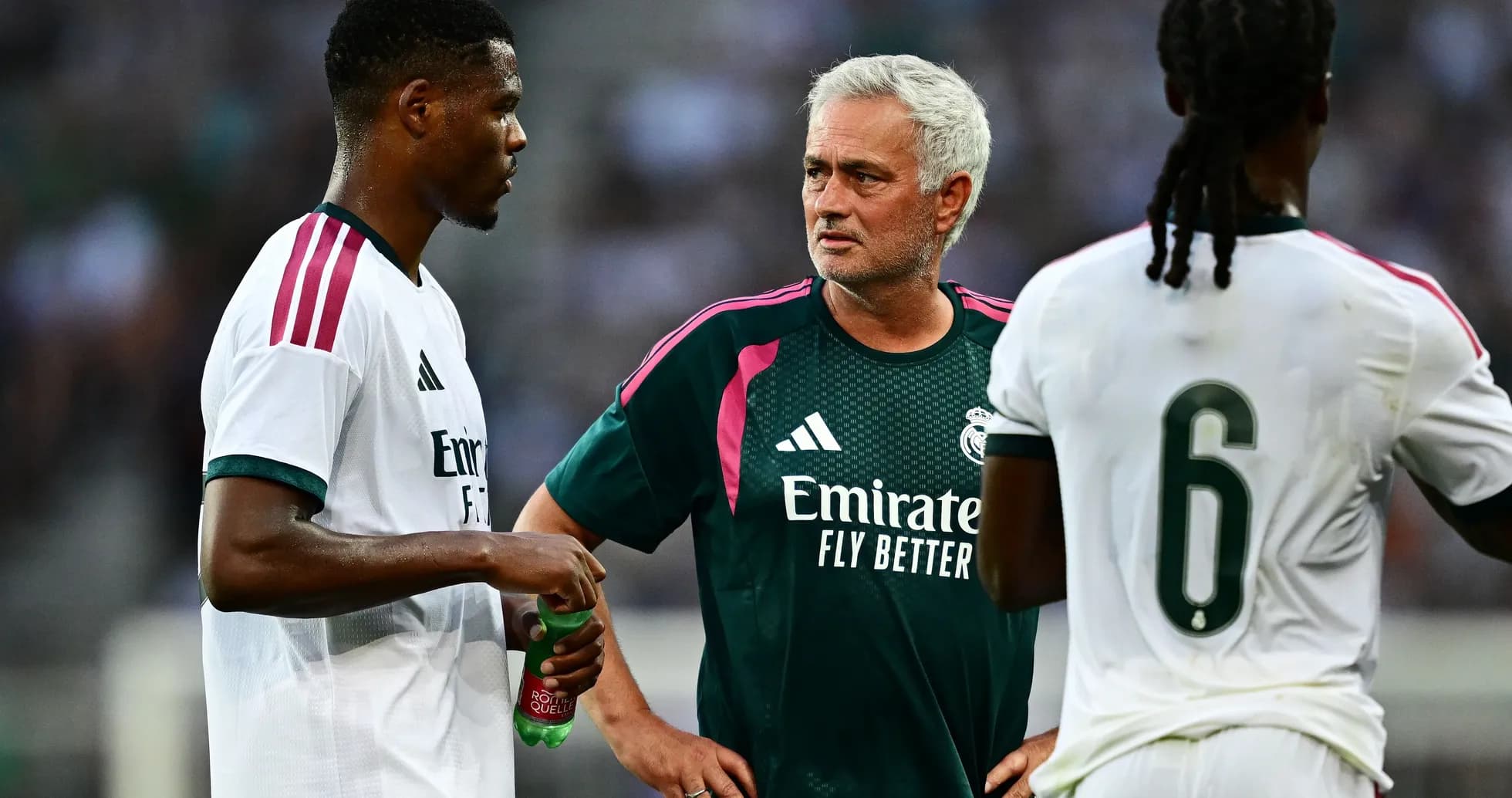 Jose Mourinho discussing strategy with players during training
