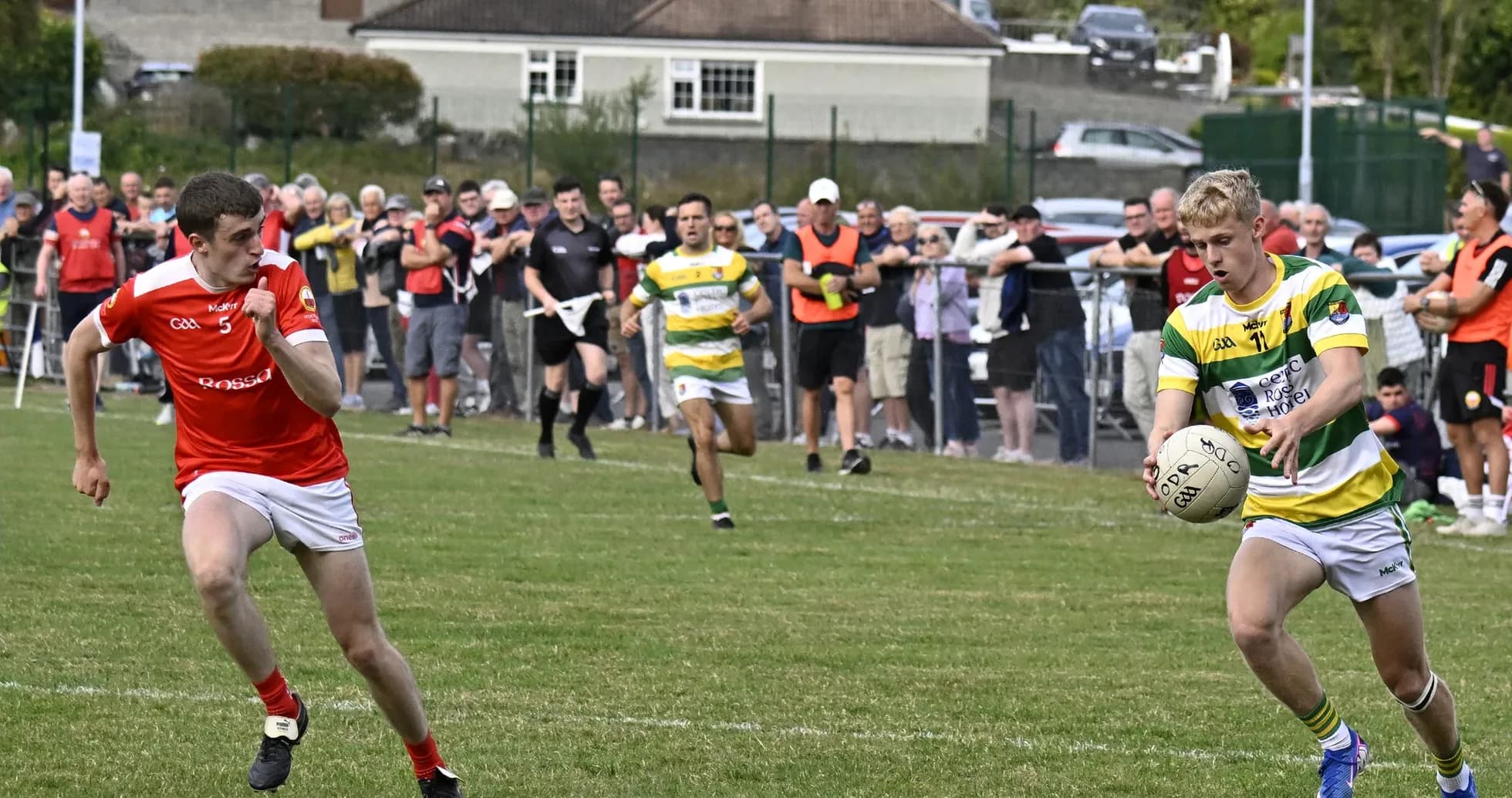 Player in yellow and green receiving ball during match