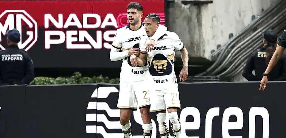 Pumas players celebrating a goal during match